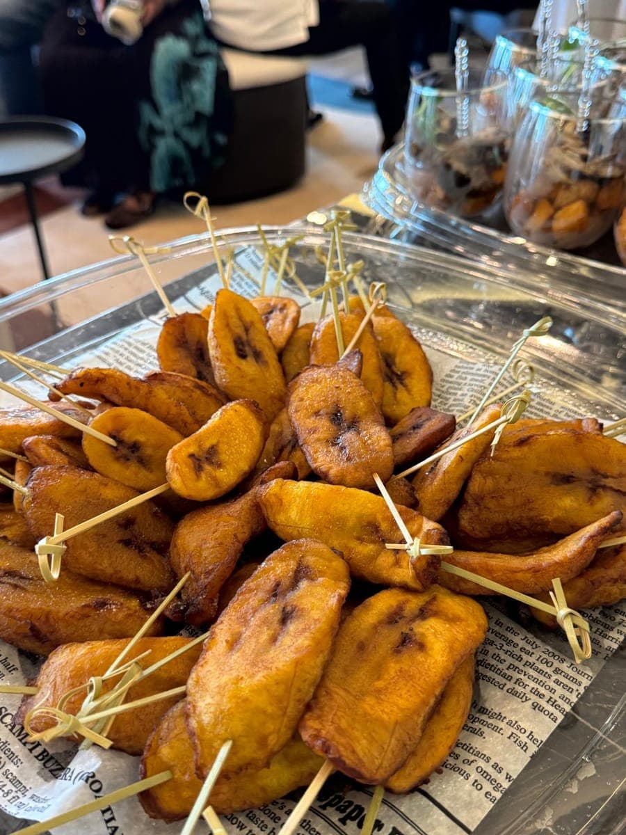 A pile of fried plantain slices on skewers